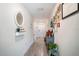 Hallway featuring wood-look tile floors, leading to the front door, with decorative elements and personal touches along the walls at 708 Simone Ct, Haines City, FL 33844