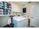 Functional laundry room with washer, dryer, shelving, and ample storage space at 708 Simone Ct, Haines City, FL 33844