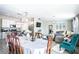 Open living space with dining area, kitchen, and living room featuring a comfortable sectional and modern decor at 708 Simone Ct, Haines City, FL 33844