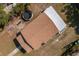 An aerial shot showcasing the roof of a house and the surrounding property with green and brown lawns at 750 Avenue O Sw, Winter Haven, FL 33880