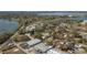 Overhead view of a neighborhood next to a body of water, highlighting houses, businesses and the surrounding landscape at 750 Avenue O Sw, Winter Haven, FL 33880