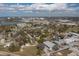 Wide aerial view of a town, with a lake in the distance and a house in the center at 750 Avenue O Sw, Winter Haven, FL 33880