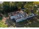 Aerial view of a backyard with an old storage shed, mature trees, and a vehicle parked nearby at 750 Avenue O Sw, Winter Haven, FL 33880