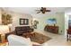 Spacious living room area with tile flooring, a ceiling fan, and a television set at 762 Canberra Rd, Winter Haven, FL 33884