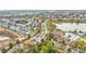 An aerial view shows the townhouses, community pool, lake, and landscaping at 7759 Basnett Cir, Kissimmee, FL 34747