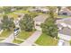 Stunning aerial view of a home featuring lush landscaping, a manicured lawn and a paved driveway at 7759 Basnett Cir, Kissimmee, FL 34747