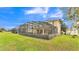 Expansive screened-in patio and backyard of a well-maintained two-story single Gathering home at 7759 Basnett Cir, Kissimmee, FL 34747