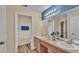 Bathroom features double sinks and a door to a water closet at 7759 Basnett Cir, Kissimmee, FL 34747