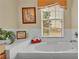 Relaxing bathroom with soaking tub, large window, and serene decor at 7759 Basnett Cir, Kissimmee, FL 34747