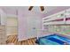 Charming bedroom features wood floors, bunk beds, and a double door closet at 7759 Basnett Cir, Kissimmee, FL 34747