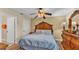Cozy bedroom with wood floors, a ceiling fan and traditional furnishings at 7759 Basnett Cir, Kissimmee, FL 34747