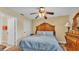 Well-lit bedroom featuring a classic design with hardwood floors and a traditional-style ceiling fan at 7759 Basnett Cir, Kissimmee, FL 34747