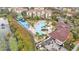 An aerial view showcases the community pool, splash pad, and surrounding landscaping at 7759 Basnett Cir, Kissimmee, FL 34747