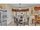 Charming dining area with stainless steel appliances and views of the pool at 7759 Basnett Cir, Kissimmee, FL 34747