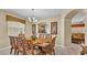 Formal dining room featuring a large table, seating for eight, and elegant chandelier at 7759 Basnett Cir, Kissimmee, FL 34747