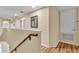 Upstairs hallway with wood floors, white trim, and natural light at 7759 Basnett Cir, Kissimmee, FL 34747