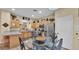 Bright, open kitchen with stainless steel appliances, and a glass-topped breakfast table for casual dining at 7759 Basnett Cir, Kissimmee, FL 34747