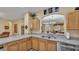 A well-maintained kitchen featuring a breakfast bar, stainless steel sink, and ample counter space at 7759 Basnett Cir, Kissimmee, FL 34747