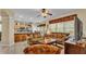 Comfortable living room featuring large windows, tile flooring, and a seamless flow into the kitchen area at 7759 Basnett Cir, Kissimmee, FL 34747