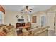 A well-lit living room showcasing comfortable sofas, a ceiling fan, and an entertainment center with a television at 7759 Basnett Cir, Kissimmee, FL 34747