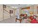 Spacious living area featuring a staircase, neutral walls, and a comfortable seating arrangement at 7759 Basnett Cir, Kissimmee, FL 34747