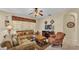 Inviting living area with plush sofas, a ceiling fan, and a television, perfect for relaxation and entertainment at 7759 Basnett Cir, Kissimmee, FL 34747