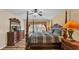 Beautiful main bedroom with a four-poster bed, warm colors, and hardwood floors at 7759 Basnett Cir, Kissimmee, FL 34747