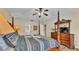Comfortable primary bedroom featuring four poster bed and a dresser with a television at 7759 Basnett Cir, Kissimmee, FL 34747