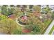 Community playground surrounded by mature trees and landscaping at 7759 Basnett Cir, Kissimmee, FL 34747