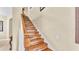 Staircase features wood steps and railing leading to the upper level at 7759 Basnett Cir, Kissimmee, FL 34747