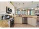 Modern kitchen featuring granite countertops, stainless steel appliances, and ample cabinet space at 819 Hart Lake St, Winter Haven, FL 33884