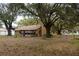 Back exterior of home featuring a screened in porch and spacious backyard at 907 Van Dr, Auburndale, FL 33823