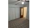 Neutral bedroom featuring carpet floors, a ceiling fan, a window, and a closet at 907 Van Dr, Auburndale, FL 33823