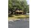 Charming single-story home featuring a mature shade tree, a well-manicured lawn, and a cozy, attached garage at 907 Van Dr, Auburndale, FL 33823