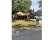 Charming one-story home with mature trees, green grass, and an attached garage at 907 Van Dr, Auburndale, FL 33823