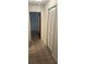 Hallway featuring carpeted floors, neutral paint, and closet space at 907 Van Dr, Auburndale, FL 33823