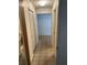 Hallway featuring carpeted floors, neutral paint, and closet space at 907 Van Dr, Auburndale, FL 33823