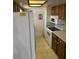 Functional kitchen features abundant cabinetry and white appliances, including a refrigerator and electric range at 907 Van Dr, Auburndale, FL 33823