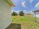 Fenced backyard in a grassy area with a blue sky at 91 W Cedarwood Cir, Kissimmee, FL 34743