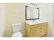 Bathroom displaying toilet, vanity and mirror with lighting at 91 W Cedarwood Cir, Kissimmee, FL 34743
