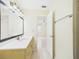 Bathroom displaying toilet, vanity and mirror with lighting. Door to bedroom and shower at 91 W Cedarwood Cir, Kissimmee, FL 34743
