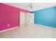 Bright bedroom with colorful walls, closet, and tile floors, awaiting personal touches at 91 W Cedarwood Cir, Kissimmee, FL 34743