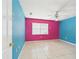 Spacious bedroom with tiled floors featuring a ceiling fan and bright accent wall at 91 W Cedarwood Cir, Kissimmee, FL 34743