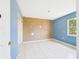 An empty bedroom showing tiled floors and a partially painted walls at 91 W Cedarwood Cir, Kissimmee, FL 34743