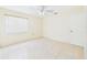 Bedroom featuring neutral walls, tiled floor, a window with blinds, and a closet at 91 W Cedarwood Cir, Kissimmee, FL 34743