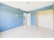 Spacious bedroom showing tiled floors and closet space at 91 W Cedarwood Cir, Kissimmee, FL 34743