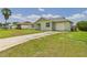 Single-story home featuring an attached garage and a well-maintained lawn at 91 W Cedarwood Cir, Kissimmee, FL 34743