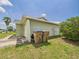 Exterior view of attached garage, with trash cans at 91 W Cedarwood Cir, Kissimmee, FL 34743