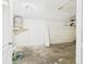Unfinished garage featuring a water heater, utility sink, and an automatic garage door at 91 W Cedarwood Cir, Kissimmee, FL 34743