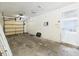 Unfinished garage with an automatic garage door and doorway leading to the kitchen at 91 W Cedarwood Cir, Kissimmee, FL 34743